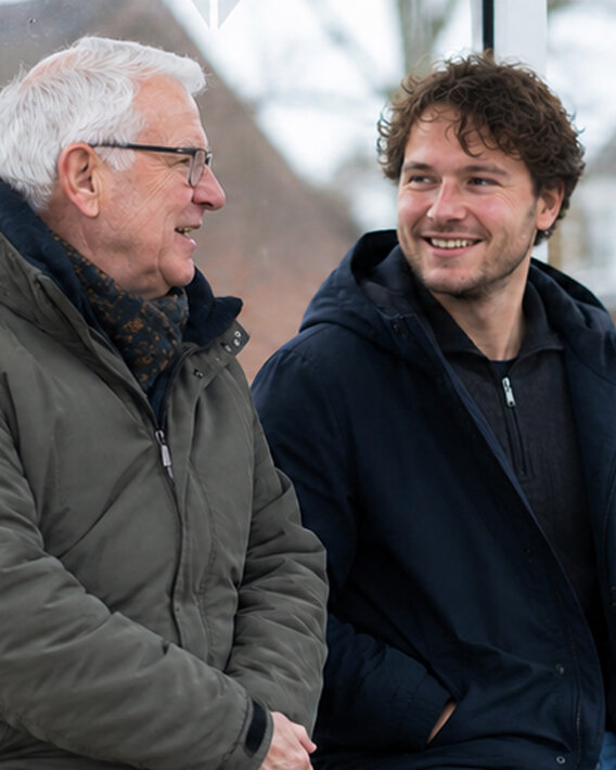 Een jongen en man in gesprek met elkaar.